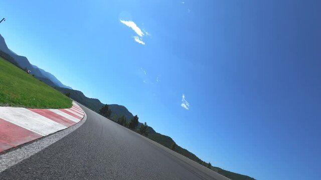Personal view of motorcycle rider driving on raceway. Feeling of speed and curvy speedway. 