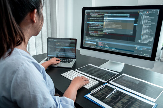 Female Programmer working in software javascript computer in IT office, Writing codes and data code website and coding database technologies to find solution to problem