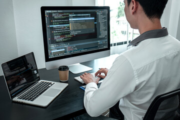 Young Programmer working in software javascript computer in IT office, Writing codes and data code website and coding database technologies to find solution to problem