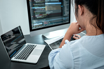 Female Programmer working in software javascript computer in IT office, Writing codes and data code...
