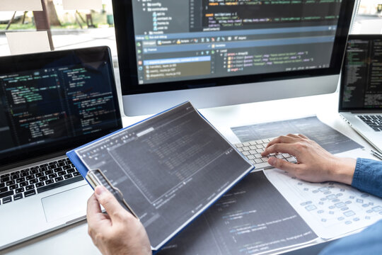 Developer programmer working on project in software development computer in IT company office, Writing codes and data code website and coding database technologies to find solution to problem