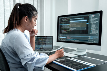 Female Programmer working in software javascript computer in IT office, Writing codes and data code website and coding database technologies to find solution to problem