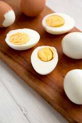 Hard Boiled Eggs on a rustic wooden board, side view. Close-up.
