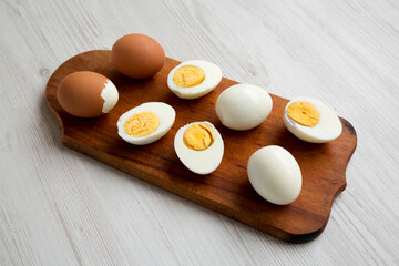 Hard Boiled Eggs on a rustic wooden board, side view.