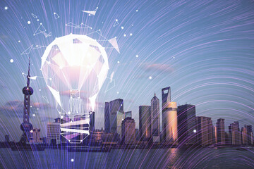 Multi exposure of bulb hologram drawing and cityscape background. Concept of idea.