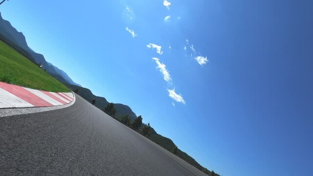 POV: fast driving motorcycle try to catch moto rider in front him on racetrack. Driving through bends. Motor race competition. 