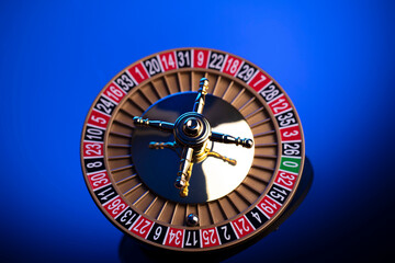 Naklejka premium Casino theme, close up of roulette, red and black numbers. Blue background.