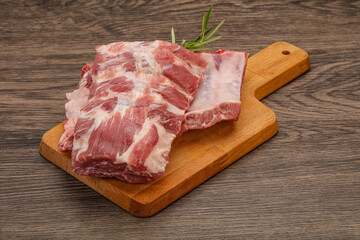 Raw pork ribs served rosemary
