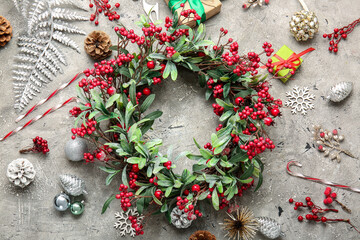 Beautiful Christmas wreath and decor on grey background