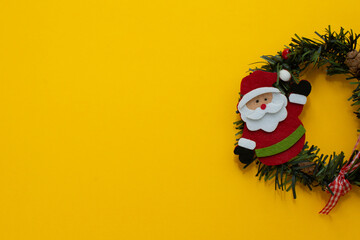 Happy New Year and Merry Christmas. Santa Claus with holiday present. Copy space, yellow background, space for text.
