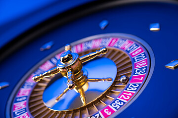 Casino theme, close up of roulette, red and black numbers. Blue background.