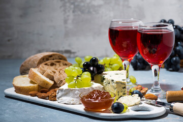 cheese plate, fresh grapes and red wine