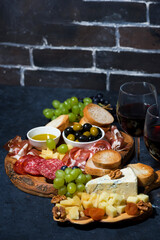 cheese platter, bread, fruit and cold cuts to wine, vertical