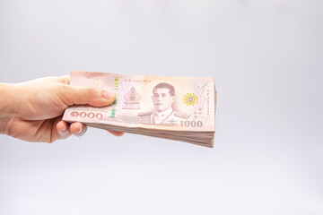hand holding Thai money