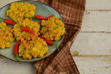 Indonesian corn fritters or Bakwan Jagung served with red chilies