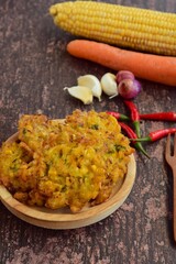 Indonesian corn fritters or Bakwan Jagung served with red chilies