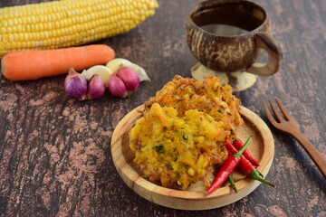 Indonesian corn fritters or Bakwan Jagung served with red chilies