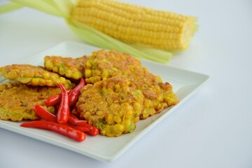 Indonesian corn fritters or Bakwan Jagung served with red chilies