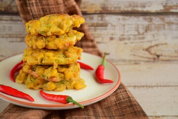Indonesian corn fritters or Bakwan Jagung served with red chilies
