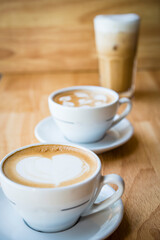 two cups of hot cappucino coffees