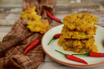 Indonesian corn fritters or Bakwan Jagung served with red chilies