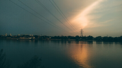 Fototapeta na wymiar Sunset over the river in the city