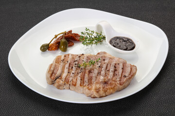 Grilled pork steak with pepper sauce