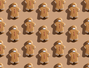 Beige pandemic art background. Seamless pattern. Christmas quarantine. Social distancing. Covid-19 winter holidays. Brown gingerbread man crowd in protective face masks isolated on light.
