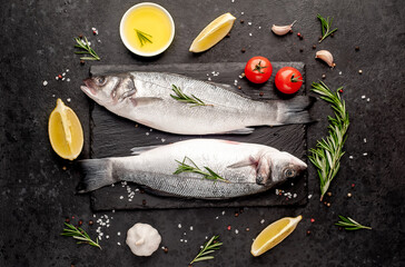 Sea bass fish with spices on a stone background