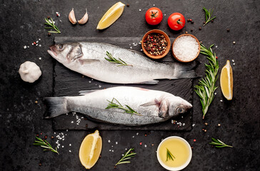 Sea bass fish with spices on a stone background