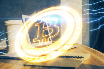 Double exposure of blockchain theme hologram and table with computer background. Concept of bitcoin crypto currency.
