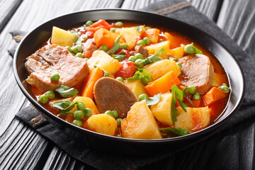 Fragrant tomato soup made from beef tongue with vegetables close-up in a bowl on the table. horizontal