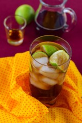 Rum and Coke Cocktail Drink with Lime Wedges and Ice Cubes. Cuba Libre