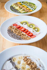 Three different Smoothie bowl with a selection of fruit granola, chia seed and coconut yogurt