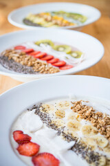 Three different Smoothie bowl with a selection of fruit granola, chia seed and coconut yogurt