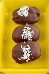 Medjool dates covered dark chocolate garnish with shredded coconut