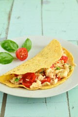 Corn tortilla filled with scrambled egg white, tomato and basil