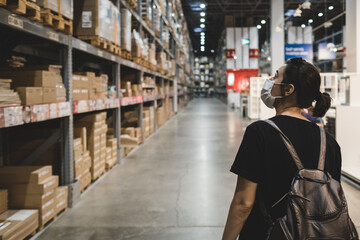 Business woman walking around in disassembled furniture store.