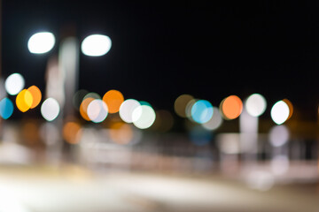 Blurred image.Night city street lights colors trendy bokeh background