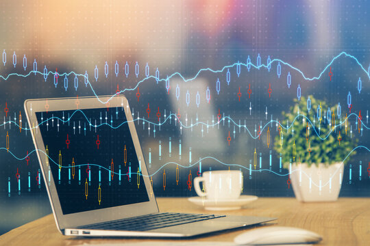 Financial graph colorful drawing and table with computer on background. Double exposure. Concept of international markets.