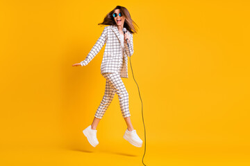 Fototapeta na wymiar Full length body size side profile photo of girl jumping with mic singing on concert isolated on vibrant color background