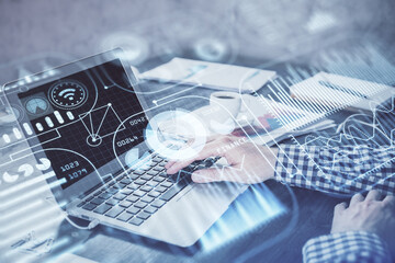 Technology theme hologram with man working on computer on background. High tech concept. Double...