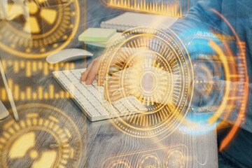 Technology theme hologram with man working on computer on background. High tech concept. Multi exposure.