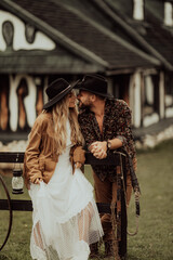 Loving couple on a  ranch in the western mountains in the autumn season. Elopement concept