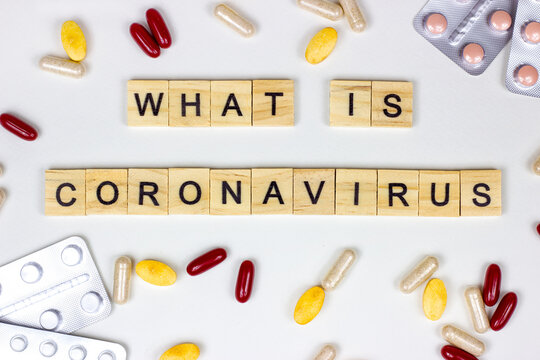 The Medical Phrase What Is Coronavirus With Pills, Capsules And Tablets On Light Background. Epidemic Alert Concept.