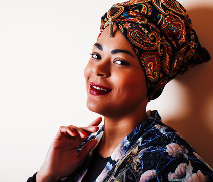 beauty bright african woman with creative make up, shawl on head like cubian closeup smiling