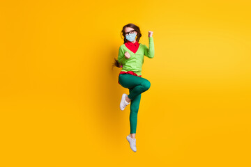 Full length body size view of attractive successful cheerful girl jumping rejoicing wear mask isolated yellow color background