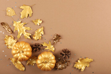Fototapeta premium Beautiful stylish autumn background with golden leaves and pumpkins top view with place for text