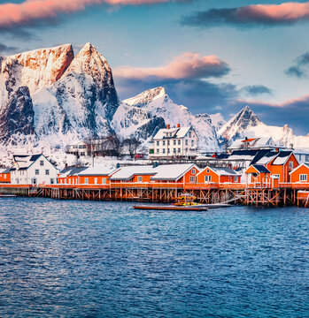 Fantastic winter sunrise on Gravdal bay. Colorful morning scene of popular tourist destination - Lofoten Islands. Beautiful seascape of Norwegian sea. Frosty winter landscape of Sakrisoy village.