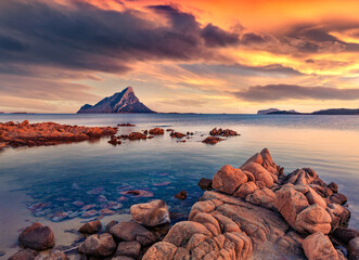 Fantastic sunset with Tavolara mountain on background. Astonishing summer seascape of Mediterranean...